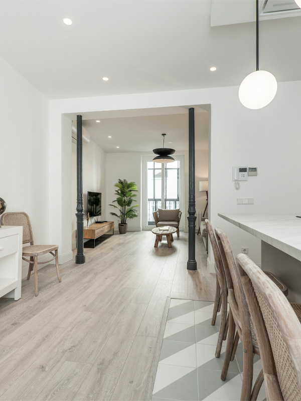 Kitchen hallway leading to living room with vinyl flooring